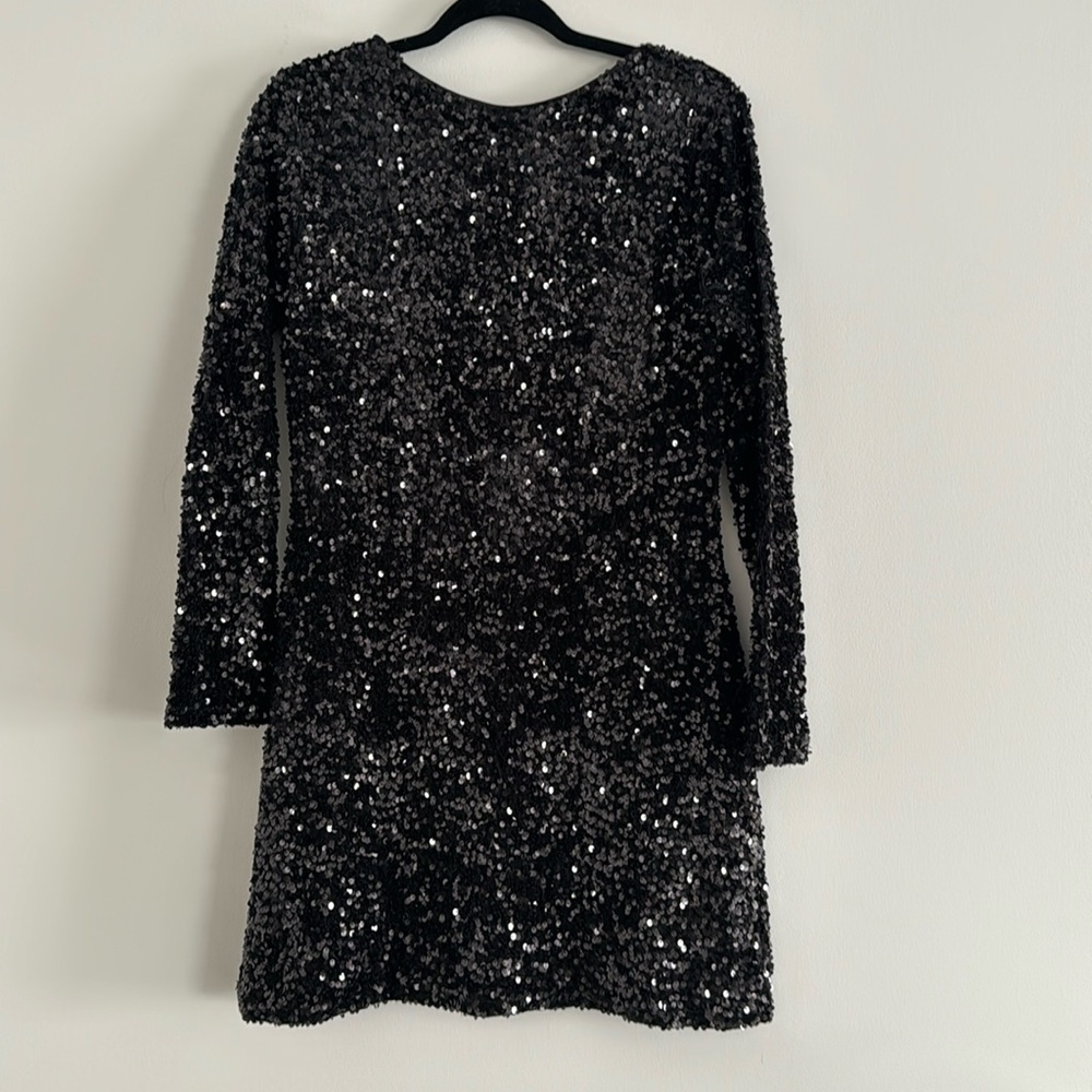 Brand new . Black sequined dress with low cut back